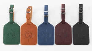 Five assorted PU leather luggage tags with compass embossed pattern in vibrant colors