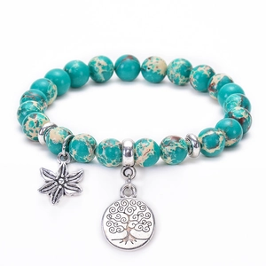 Detailed shot of teal Jasper beads with silver Tree of Life and star pendants