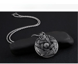 Macro detail of vintage pentagram star pendant with textured blackened silver finish