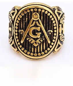Close-up of vintage gold stainless steel Freemason ring with black enamel details