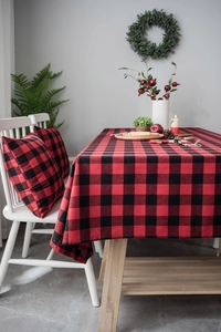 Close-up of classic red and black buffalo plaid tablecloth with matching pillow covers