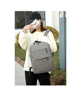 Detailed view of grey waterproof backpack with USB charging port and lateral zipper pockets