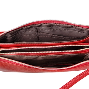 Interior view of red leather crossbody bag featuring triple compartments and five card slots