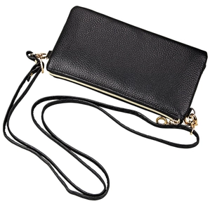 Detail of black lychee grain leather handbag with premium gold zipper and metal hooks