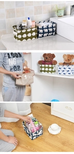 Detail of cotton linen storage baskets with cute animal prints and durable side handles