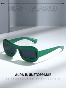 Detail of dark green cat-eye sunglasses with sleek resin frames and dark grey lenses