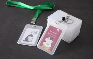 Macro view of transparent card holders with green lanyards and metallic keyrings