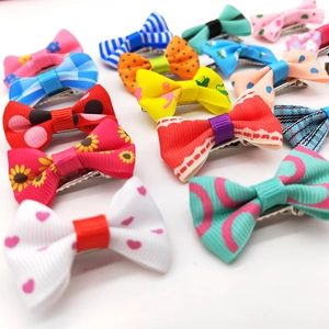 Colorful pet bow clips set with polka dots and floral patterns in various bright colors