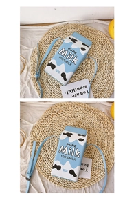 Detail of blue and white milk carton crossbody bag with Pure Milk print on textured mat