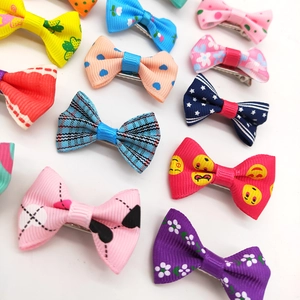 Close-up of assorted colorful grosgrain ribbon bow hair clips with diverse patterns