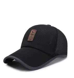 Detailed close-up of breathable black mesh material and side leather patch on baseball cap