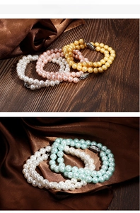 Detail of double-strand pearl bracelet with multi-color luster and silver metal clasp