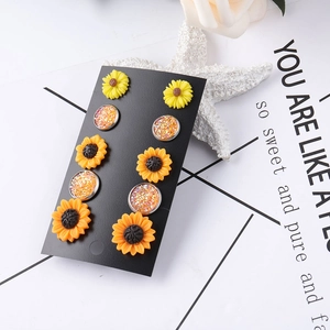 Detail view of 5-pair daisy and crystal stud earring set on black display card
