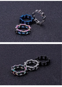 Detail view of titanium steel chain rings in silver, black, blue, and rainbow finishes