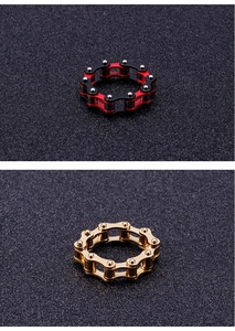 Close-up of industrial punk chain rings in gold and red-black plated stainless steel