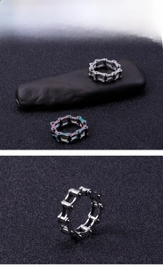 Macro detail of industrial stainless steel bicycle chain rings in silver and rainbow tones
