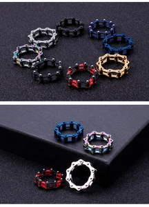 Industrial style titanium steel chain rings in various colors on a textured background