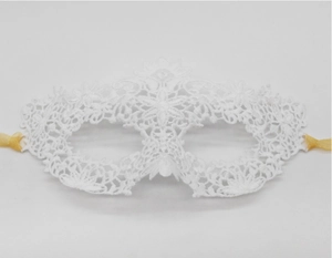 Detailed macro view of white crochet lace mask with golden satin ties for costume parties