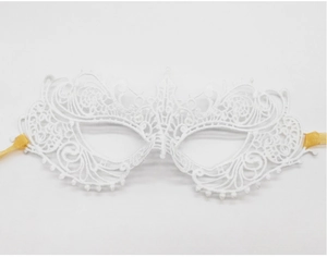 Close-up of white lace party mask with intricate hollow patterns and gold silk ribbons