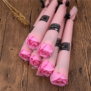 Detail view of pink soap roses in individual packaging with black ribbons and tags