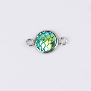 Detail of 10mm round fish scale pendant with green and yellow sequins in silver frame