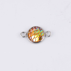 Macro view of 10mm stainless steel round pendant with golden fish scale pattern and dual loops