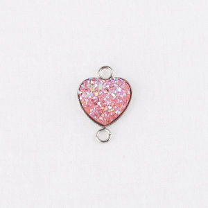 Detail of 13mm heart-shaped pendant connector with pink glitter resin in silver frame
