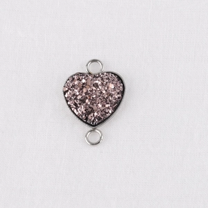 Detail of 13mm heart-shaped pendant with pink glitter inlay and silver metal frame