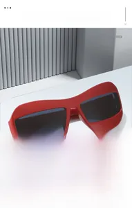Detail of red oversized cat-eye sunglasses with thick geometric frames in a 3D studio setting