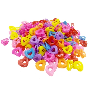 Close-up of heart-shaped mini hair claws in vibrant assorted colors on white background