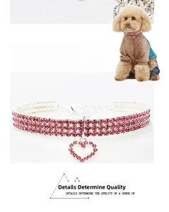Close-up of pink rhinestone pet collar with a heart-shaped crystal pendant and silver chain