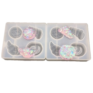 Macro view of silicone resin molds for croissant and seashell shaped DIY pendants
