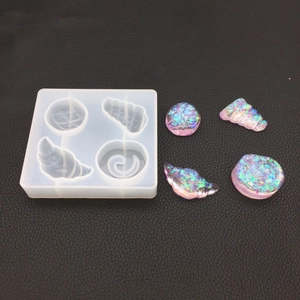 Silicone resin mold featuring conch and seashell shapes with glittery finished pendants