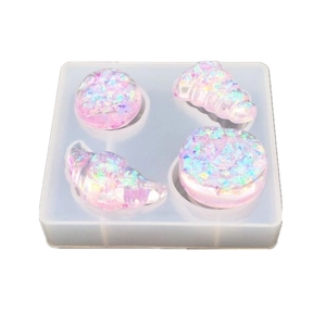 DIY resin silicone mold featuring seashell and pastry shapes with purple glitter finish