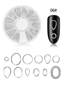 Silver metal nail art studs set with stars moon patterns in a 12-slot storage box