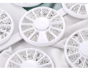 Macro shot of 12-slot storage box with silver celestial metal nail art charms