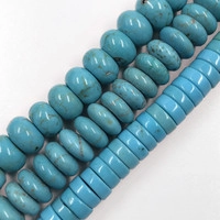 Macro shot of turquoise stone beads in flat round and barrel shapes for DIY jewelry