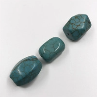 Macro detail of three natural blue turquoise spacer beads with brown mesh veins on white