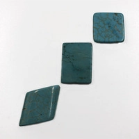 Detailed view of turquoise stones in rhombus, rectangle and square shapes with brown veins