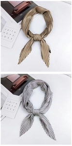 Detail of pleated rhombic scarves in khaki and light gray with fine accordion texture