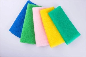 Detailed texture of colorful nylon exfoliating back scrubbers in five bright colors
