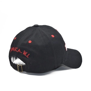 Close-up of the adjustable bronze metal buckle and Jamaica embroidery on the cotton cap