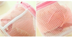 Close-up of pink zipper and honey-comb mesh on a cylindrical bra washing bag
