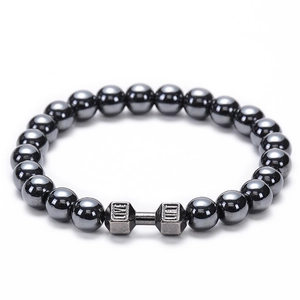 Close-up of matte black beads bracelet with silver dumbbell featuring Live Lift engraving