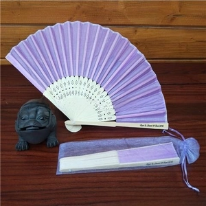 Detail of purple organza drawstring pouch and customized bamboo folding hand fan