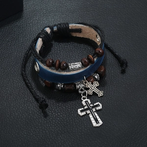 Multilayer leather beaded bracelet with metal cross charms on black background