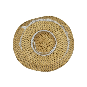 Straw sun hat with white lace trim and elastic wind string in top view flat lay
