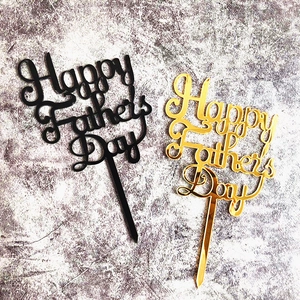 Detail of black and gold acrylic Happy Father's Day cake toppers on textured background