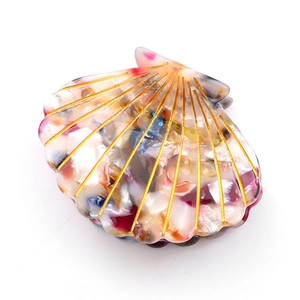Minimalist seashell hair claw with colorful shell pattern and gold vein accents