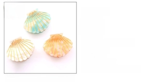 Detailed close-up showing acetate material shell hair clips in multiple vibrant colors